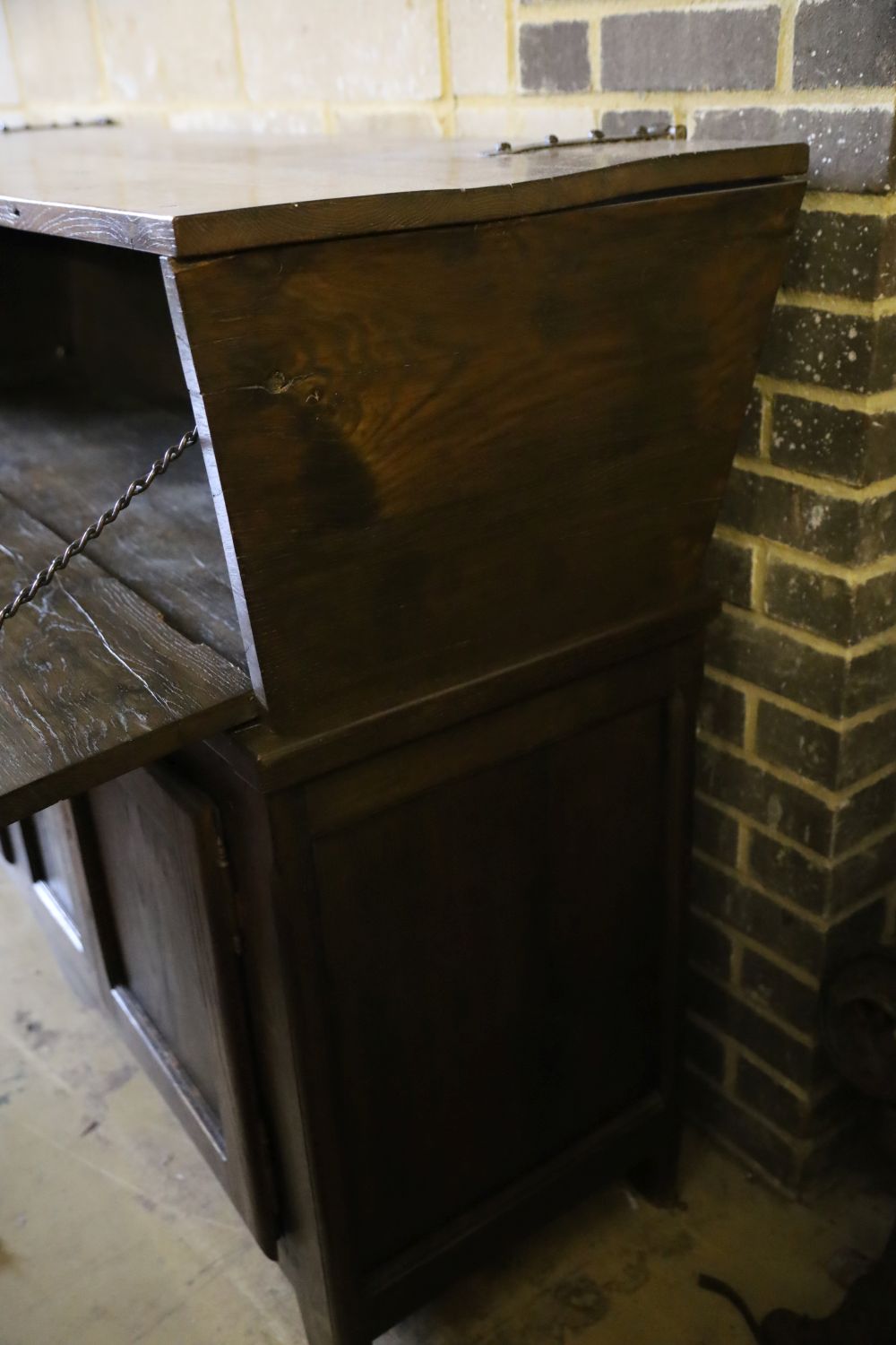 A French elm dough bin on cabinet base fitted two doors and a small central drawer, width 162cm, depth 51cm, height 112cm